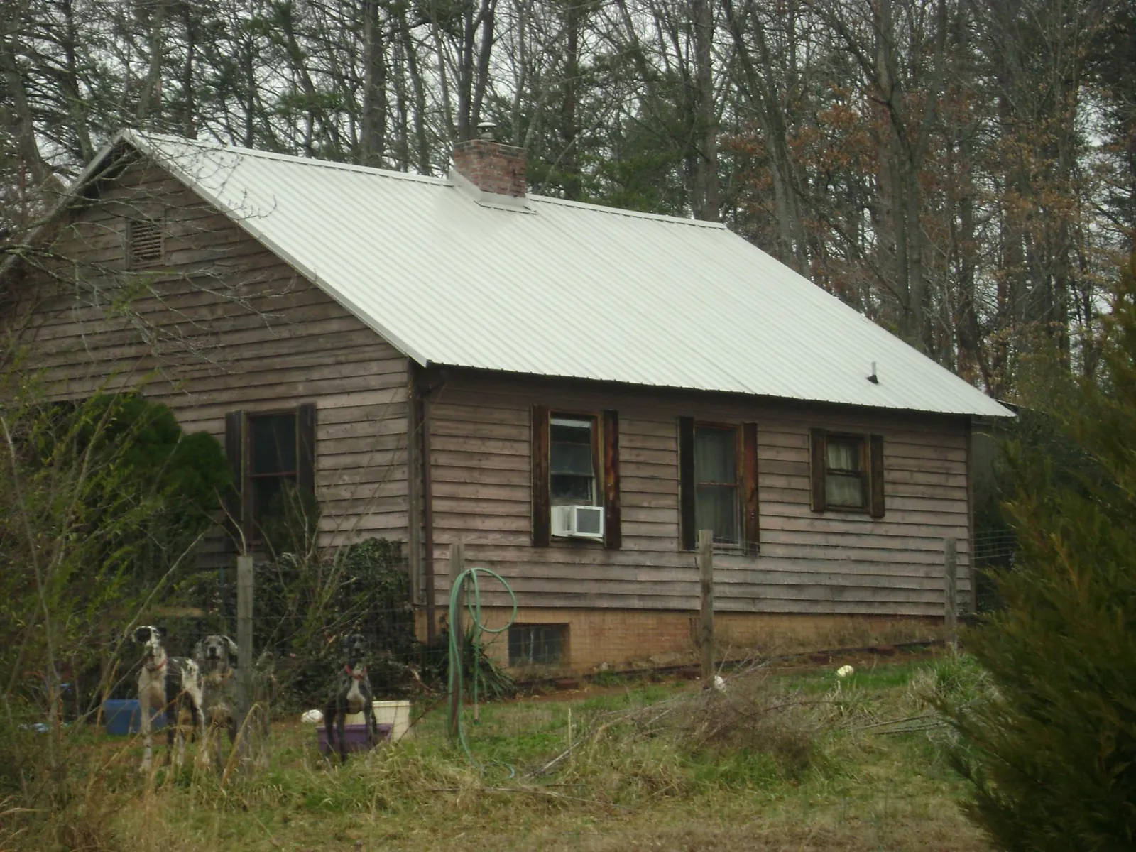 White metal roof on an old wood sided farmhouse, from a Metal Roof Installation job in Kingsbury
